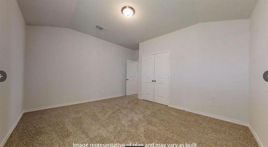 Carpeted empty room with lofted ceiling and baseboards