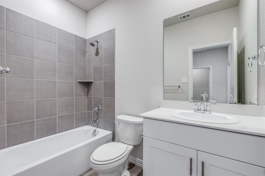 Full bathroom featuring shower / bath combination and vanity