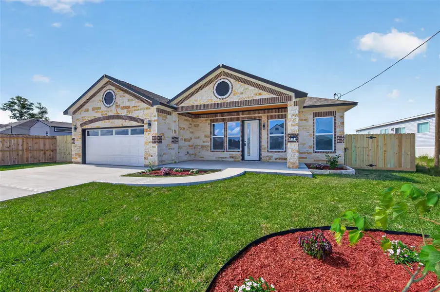 Beautiful front elevation with mature landscaping, covered entry, and custom architectural details. Beautiful front elevation with mature landscaping, covered entry, and custom architectural details.