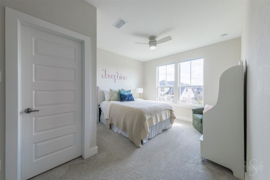 Another spacious upstairs bedroom is beautifully illuminated by a pair of large windows and offers room for a reading or study area. Neutral tones provide a sophisticated backdrop for any style. Another spacious upstairs bedroom is beautifully illuminated by a pair of large windows and offers room for a reading or study area. Neutral tones provide a sophisticated backdrop for any style.
