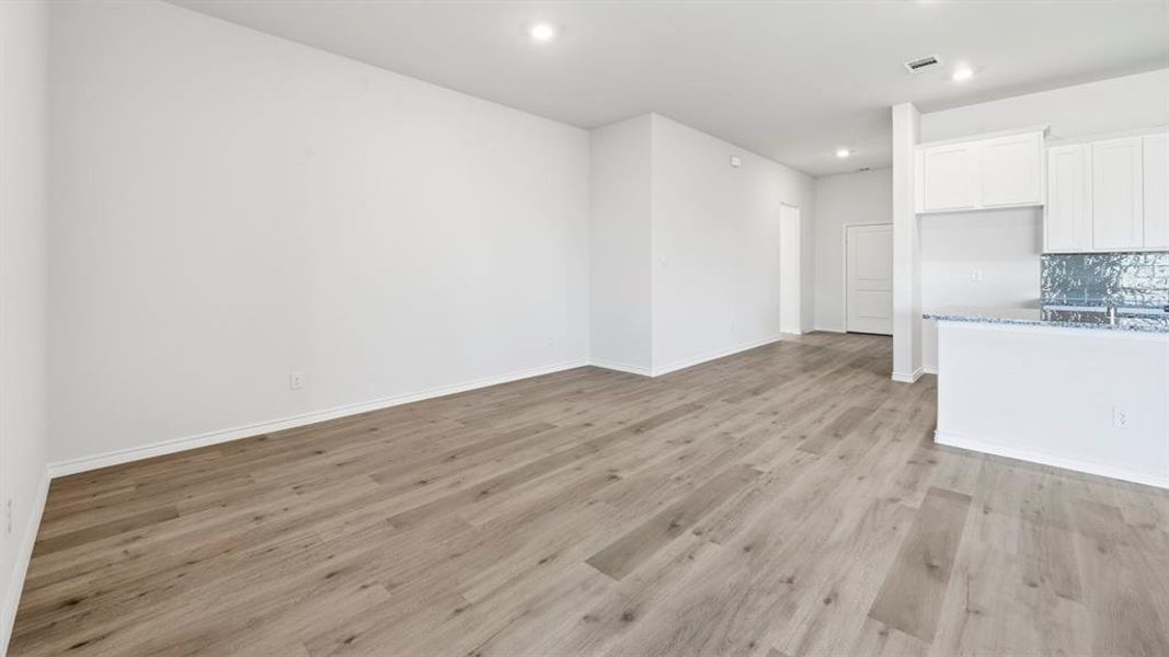 Unfurnished living room featuring light wood-type flooring and recessed lighting