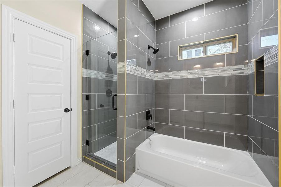 Full bath featuring tiled shower, tile patterned floors, and a bathtub Full bath featuring tiled shower, tile patterned floors, and a bathtub