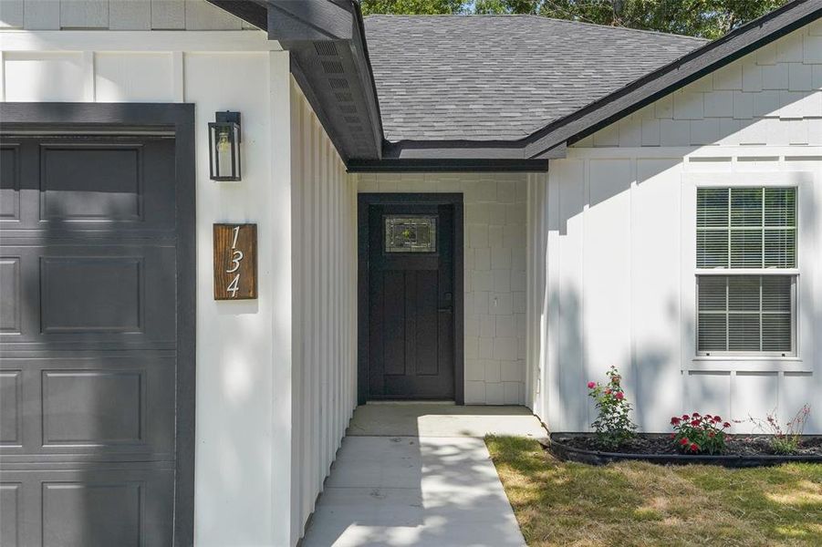White board and batten siding with contrasting dark trim details White board and batten siding with contrasting dark trim details