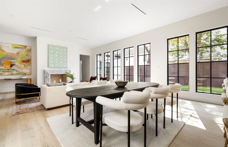Dining space featuring healthy amount of natural light and light wood-style flooring Dining space featuring healthy amount of natural light and light wood-style flooring