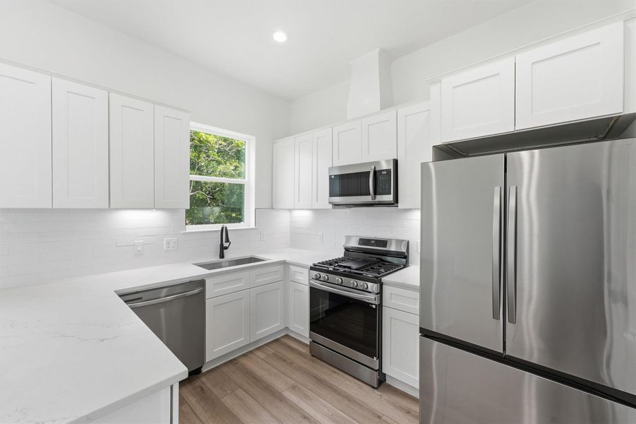 Cook like a pro from day one. This chef's kitchen comes fully equipped with a stainless gas range, built-in microwave, French door refrigerator, and under-cabinet lighting that makes every meal prep feel elevated. Cook like a pro from day one. This chef's kitchen comes fully equipped with a stainless gas range, built-in microwave, French door refrigerator, and under-cabinet lighting that makes every meal prep feel elevated.