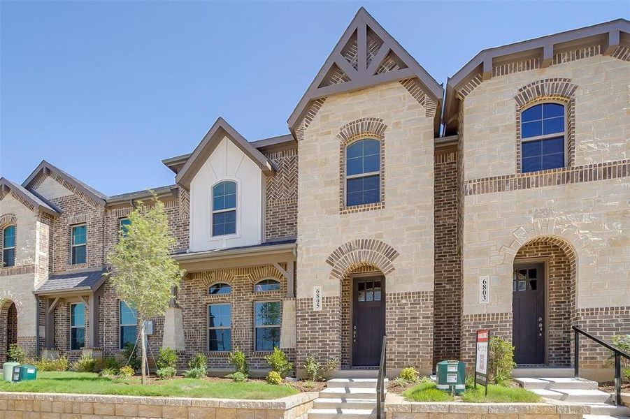 French country style house featuring brick siding and stone siding French country style house featuring brick siding and stone siding