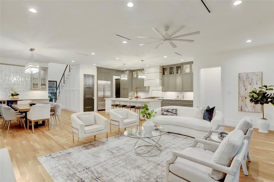 Another view of the open concept, great room, dining room and kitchen. Notice the hallway leading to the primary suite.