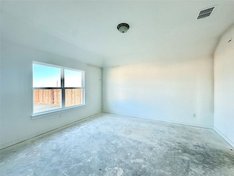 Spare room with unfinished concrete flooring