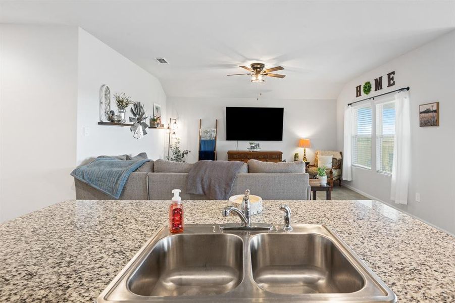 Kitchen featuring open floor plan and ceiling fan