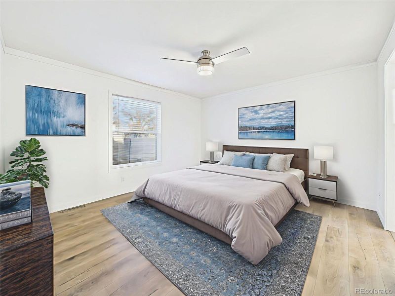 Bedroom #1 Virtually Staged A bright and airy primary suite with large window, ceiling fan, and ample space for a king bed and additional furniture.