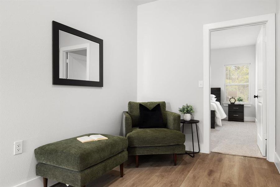 Sitting room featuring baseboards and wood finished floors