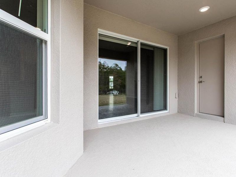 And, your new home even includes outdoor living space, with a sliding glass door from the gathering room and a convenient pool door to the hall bath - New home for sale in  Winter Haven, FL