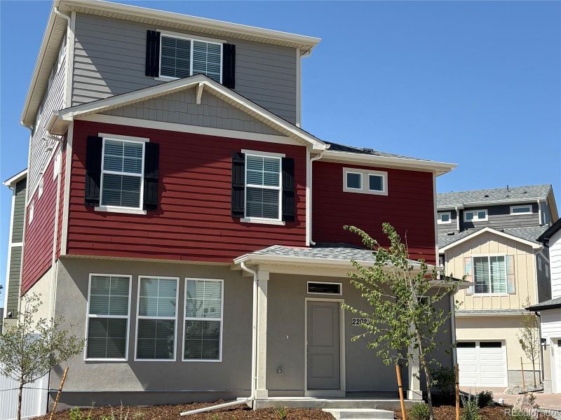 Front exterior of a new home in Green Valley Ranch, Aurora, CO, highlighting curb appeal (Image 2).