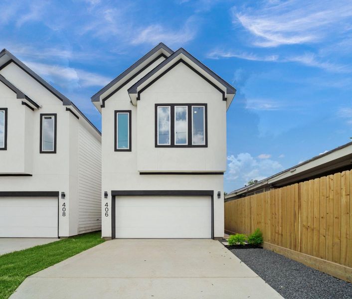 This modern two-story home features a clean, minimalist facade with black trim, private driveway, and a spacious two-car garage. This modern two-story home features a clean, minimalist facade with black trim, private driveway, and a spacious two-car garage.