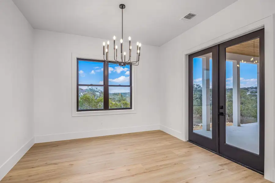 Unfurnished dining area with french doors, visible vents, a notable chandelier, and light wood finished floors