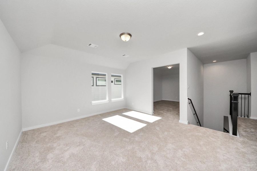 Come upstairs and enjoy a day of leisure in this fabulous game room! This is the perfect hangout spot or adult game room! Features plush carpet, high ceilings, custom paint and windows for plenty of natural light.