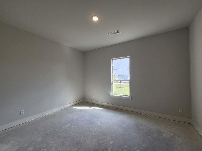 Single window with grid inserts, light gray wall paint, white trim, recessed ceiling lighting, and exposed concrete flooring