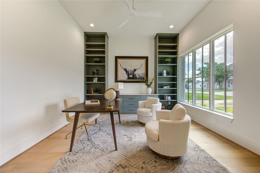 Thoughtfully designed home office offering a sophisticated work-from-home environment with bespoke shelving and serene neighborhood views.