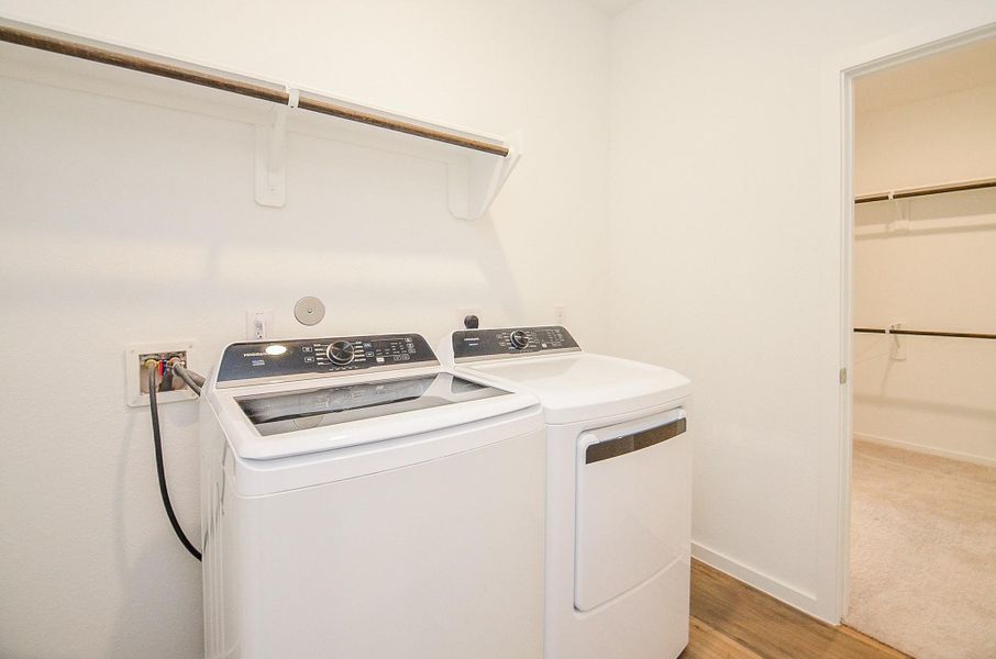 Laundry room is accessible from the hall OR primary bedroom closet- makes putting away clean laundry easy!