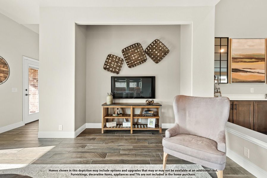 Living room nook with TV on wood console, accent chair, and decorative wall baskets on tile floors Living room nook with TV on wood console, accent chair, and decorative wall baskets on tile floors