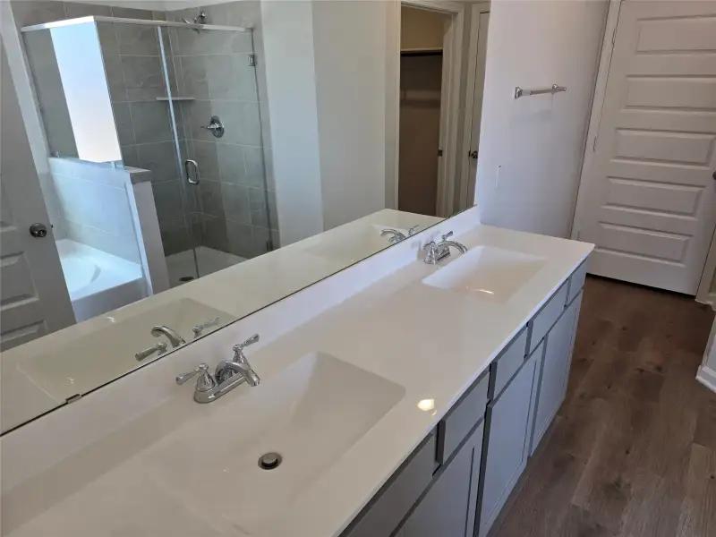 The Shetland III- Primary Bathroom with dual sinks, garden tub and separate shower. included). Home under construction, photo used for illustrative purposes only, colors and options will vary. The Shetland III- Primary Bathroom with dual sinks, garden tub and separate shower. included). Home under construction, photo used for illustrative purposes only, colors and options will vary.