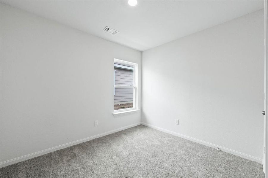Unfurnished room with baseboards and carpet floors Unfurnished room with baseboards and carpet floors