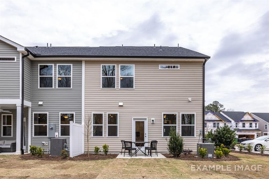 Back of house with a patio and central AC