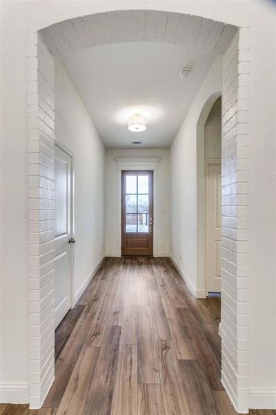 Doorway with hardwood / wood-style flooring