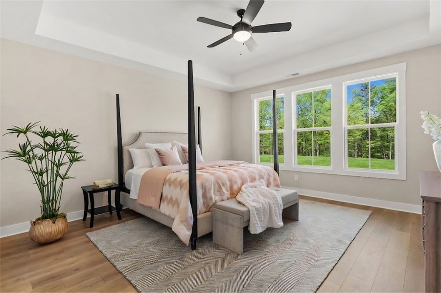 This spacious bedroom offers serene views and an i