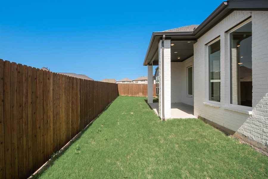 Fenced backyard featuring a patio area Fenced backyard featuring a patio area