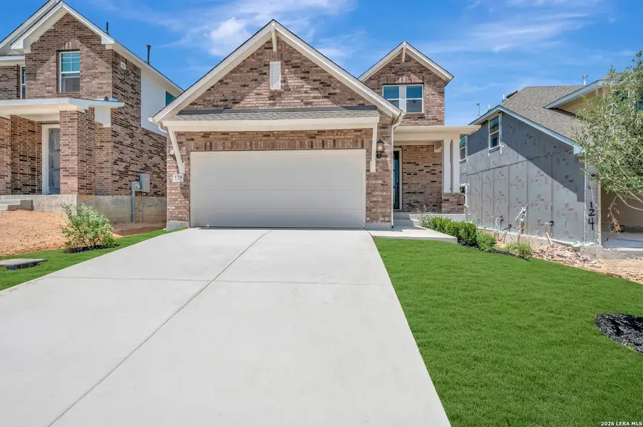 Front exterior of a new home in Mayfair - Select Garden Series, New Braunfels, TX, highlighting curb appeal (Image 1). Front exterior of a new home in Mayfair - Select Garden Series, New Braunfels, TX, highlighting curb appeal (Image 1).