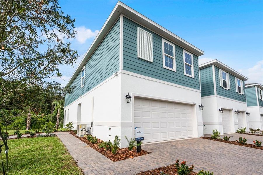Front exterior of a new home in Delaney Reserve, Deland, FL, highlighting curb appeal (Image 24).