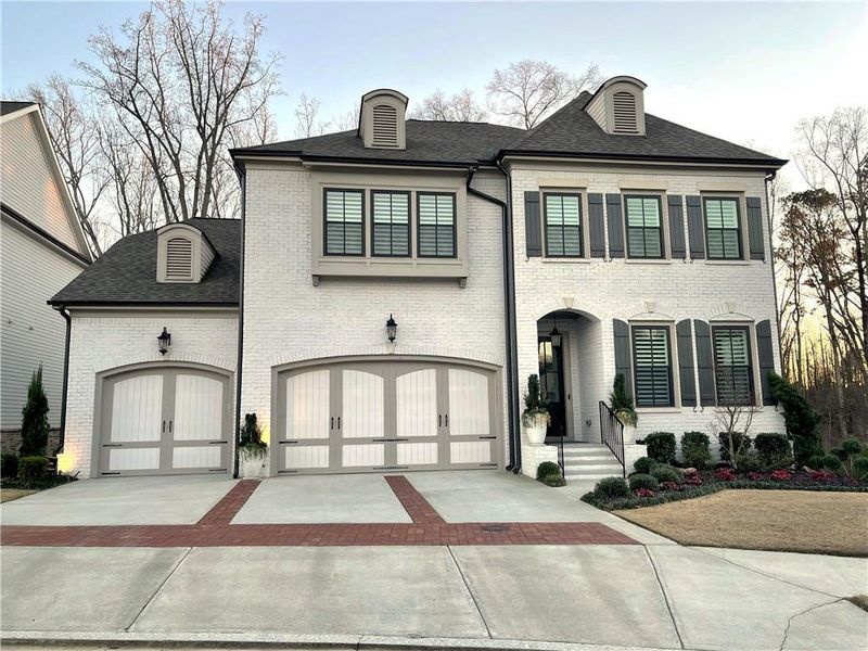 Front exterior of a new home in Bellwyn, Johns Creek, GA, highlighting curb appeal (Image 1). Front exterior of a new home in Bellwyn, Johns Creek, GA, highlighting curb appeal (Image 1).