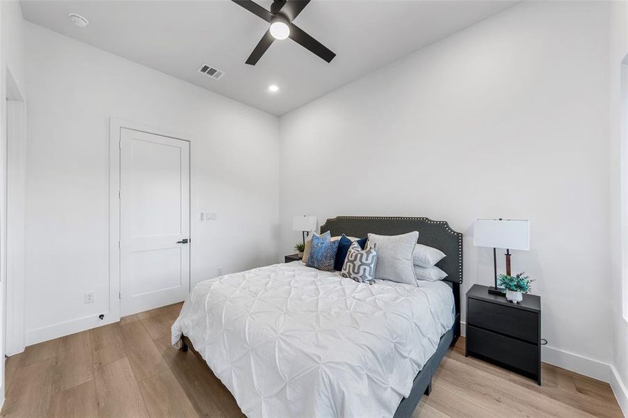Bedroom with light wood-style flooring, a ceiling fan, and recessed lighting Bedroom with light wood-style flooring, a ceiling fan, and recessed lighting