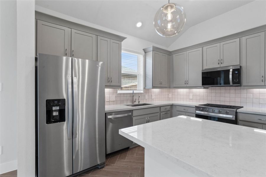 Kitchen comes equipped with a side-by-side Whirlpool refrigerator. Kitchen comes equipped with a side-by-side Whirlpool refrigerator.