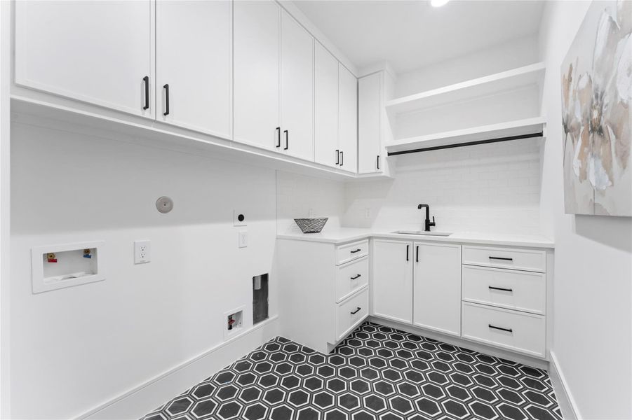 Dedicated laundry with custom cabinetry and workspace direct door entrance to primary suite