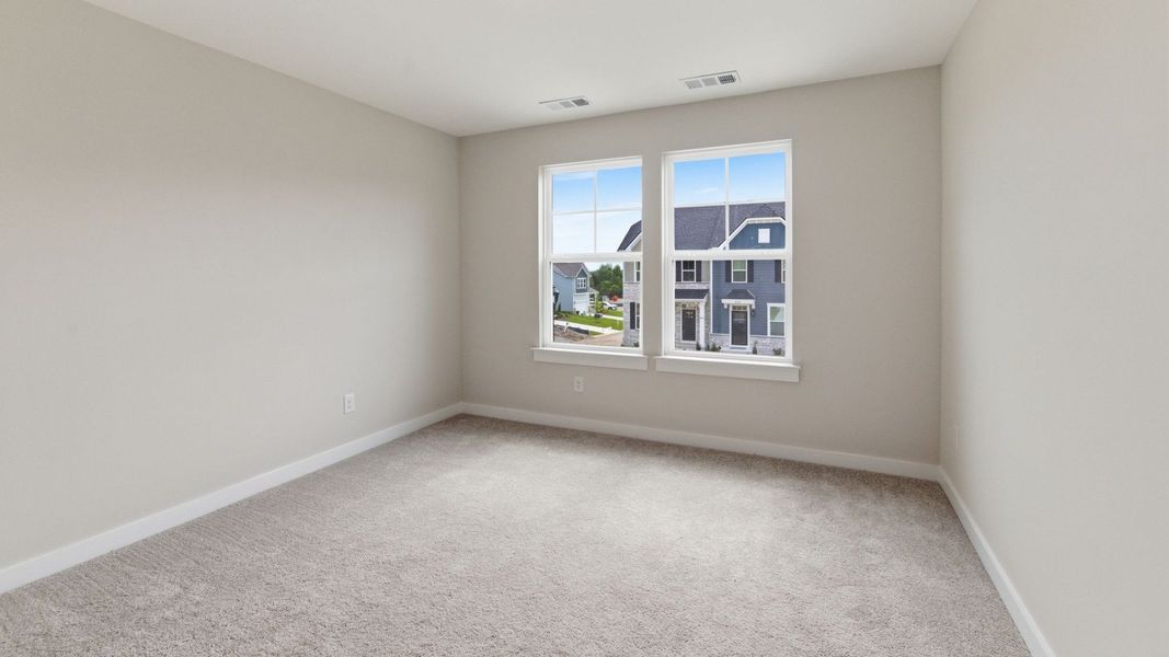 Bedroom with carpet and windows