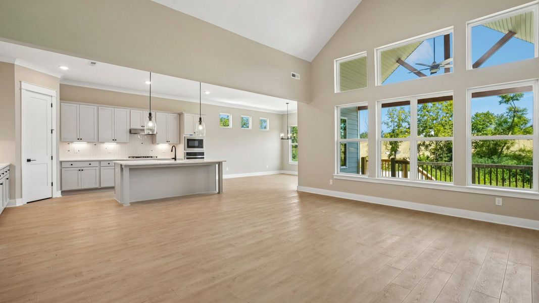 Living area next to kitchen and dining spaces Living area next to kitchen and dining spaces