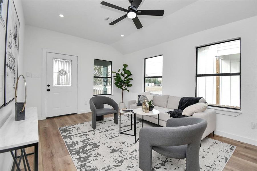 This is a modern, open-concept living space with a stylish dining area and comfortable seating, featuring clean lines, abundant natural light, and contemporary finishes.