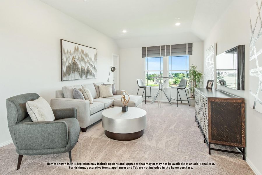 Bright living room with gray sectional sofa, round coffee table, and large windows with natural light Bright living room with gray sectional sofa, round coffee table, and large windows with natural light