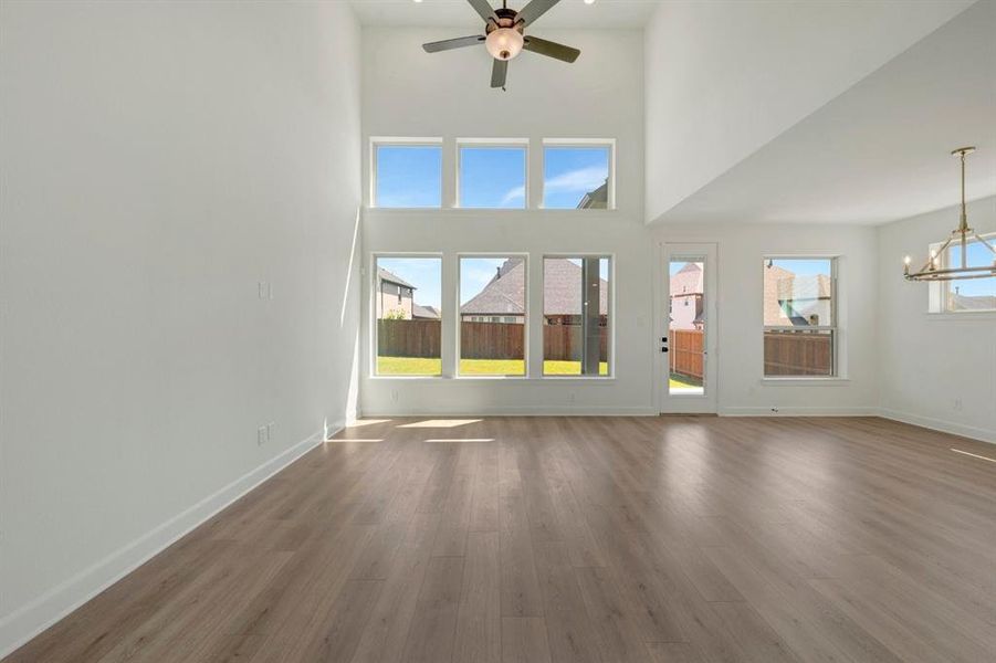 Expansive living area featuring soaring ceilings and wood-finish flooring