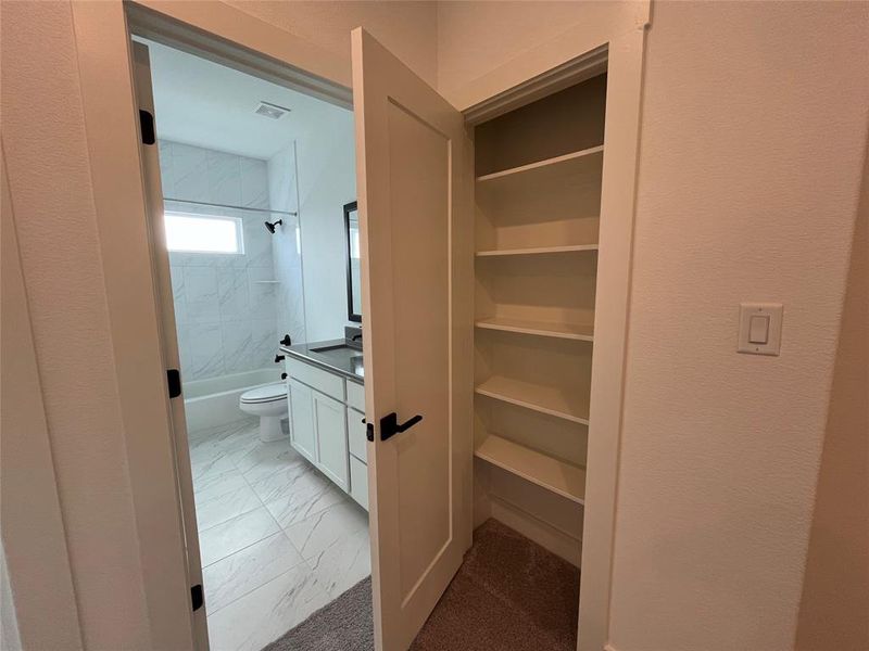 Linen closet off of guest bath