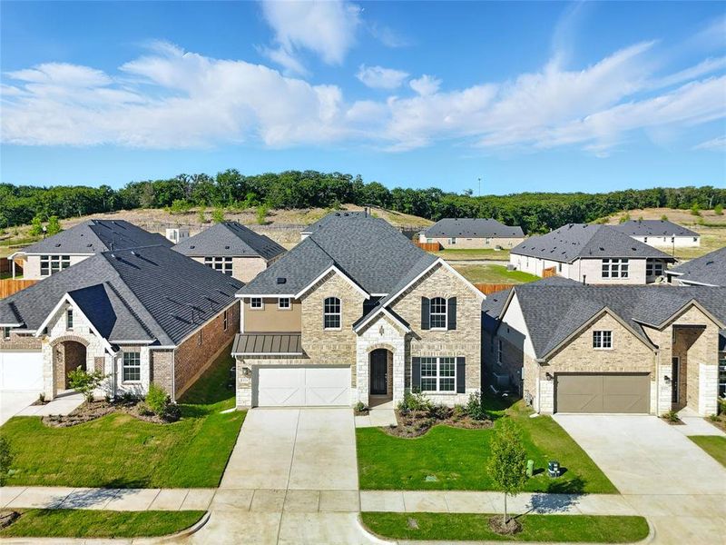 French country style house featuring driveway, stone siding, a residential view, and a front yard French country style house featuring driveway, stone siding, a residential view, and a front yard