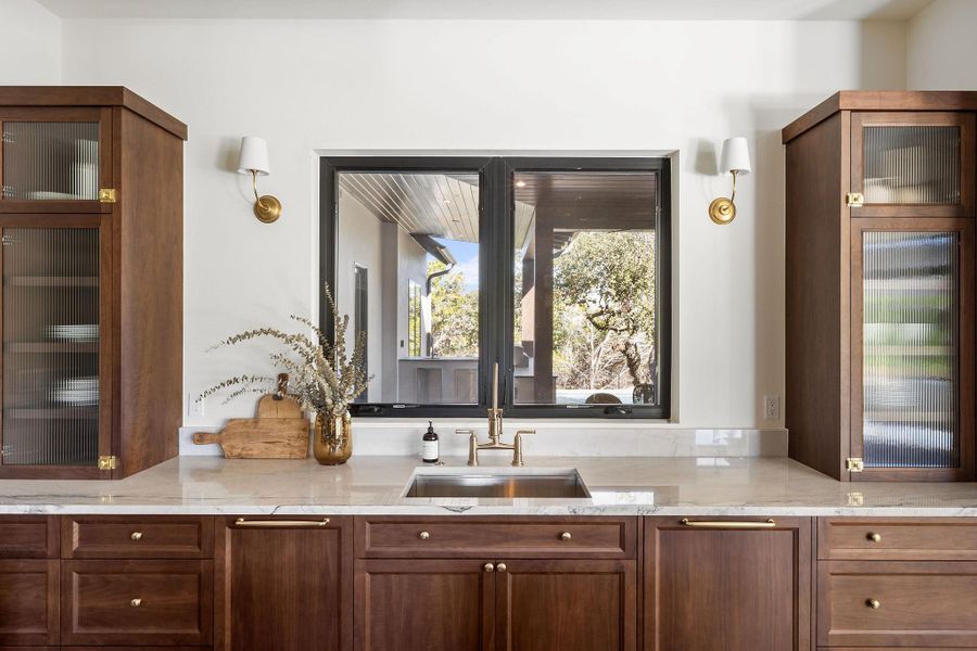 Gourmet luxury kitchen with Fantasy Luxe Quartzite Countertops, Bertazzoni Heritage Range, and Walnut Cabinets