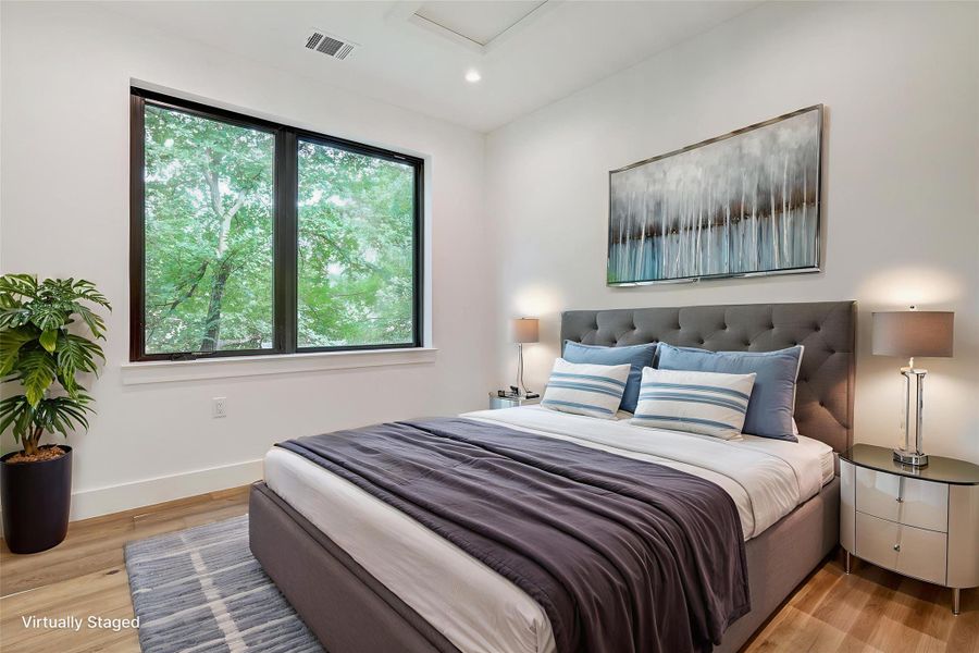 Bedroom with light wood-style flooring, recessed lighting, and attic access Bedroom with light wood-style flooring, recessed lighting, and attic access
