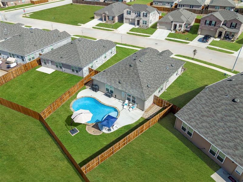 Aerial perspective of suburban area with a pool