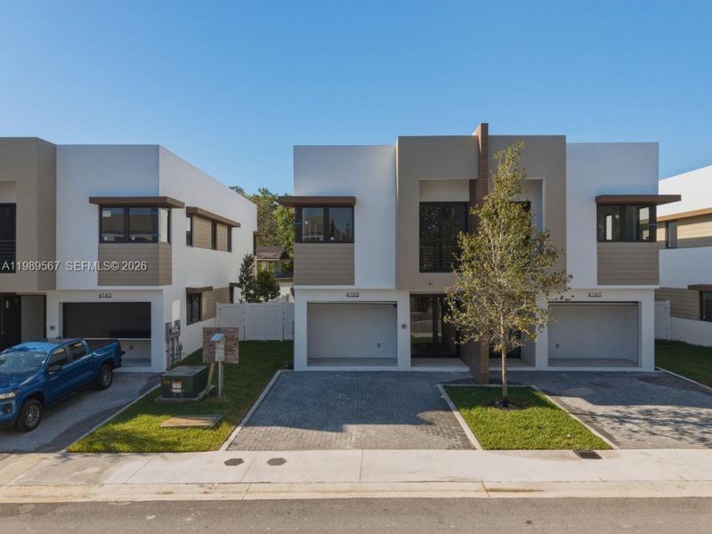 Front exterior of a new home in , Dania Beach, FL, highlighting curb appeal (Image 1). Front exterior of a new home in , Dania Beach, FL, highlighting curb appeal (Image 1).