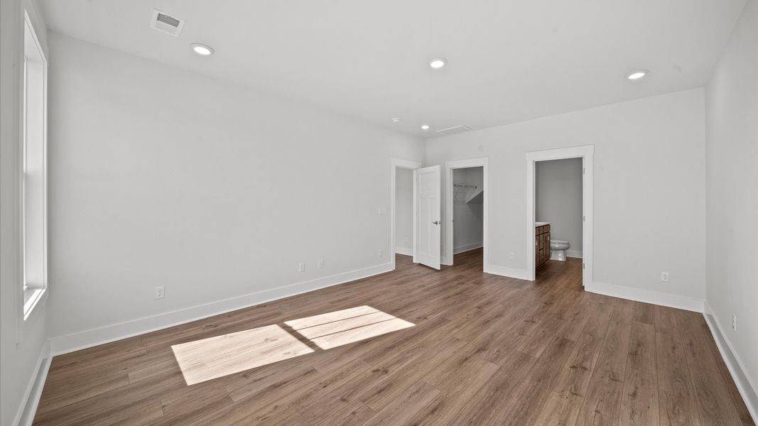 Accomplished primary retreat with eye-catching hardwood flooring in a desirable Greenville community