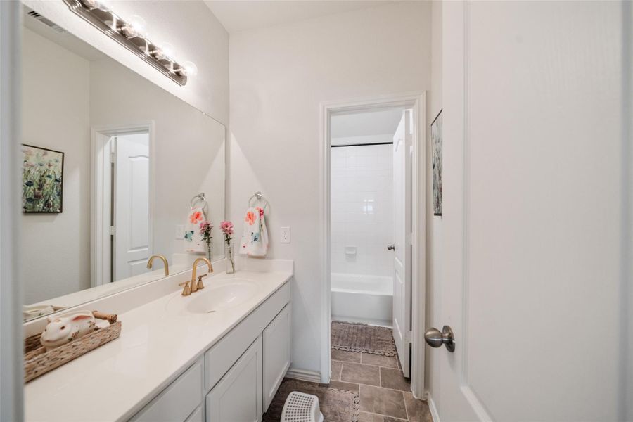Secondary bathroom upstairs has nice size counterspace and tub room for privacy