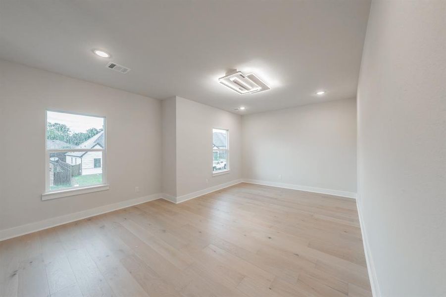 Spare room featuring light wood-type flooring and recessed lighting